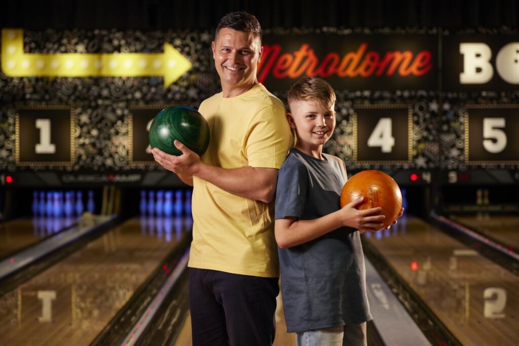 Man and son bowling