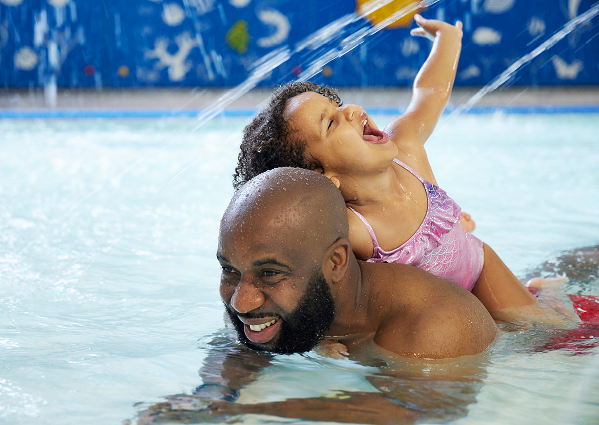 Man and daughter in swimming pool