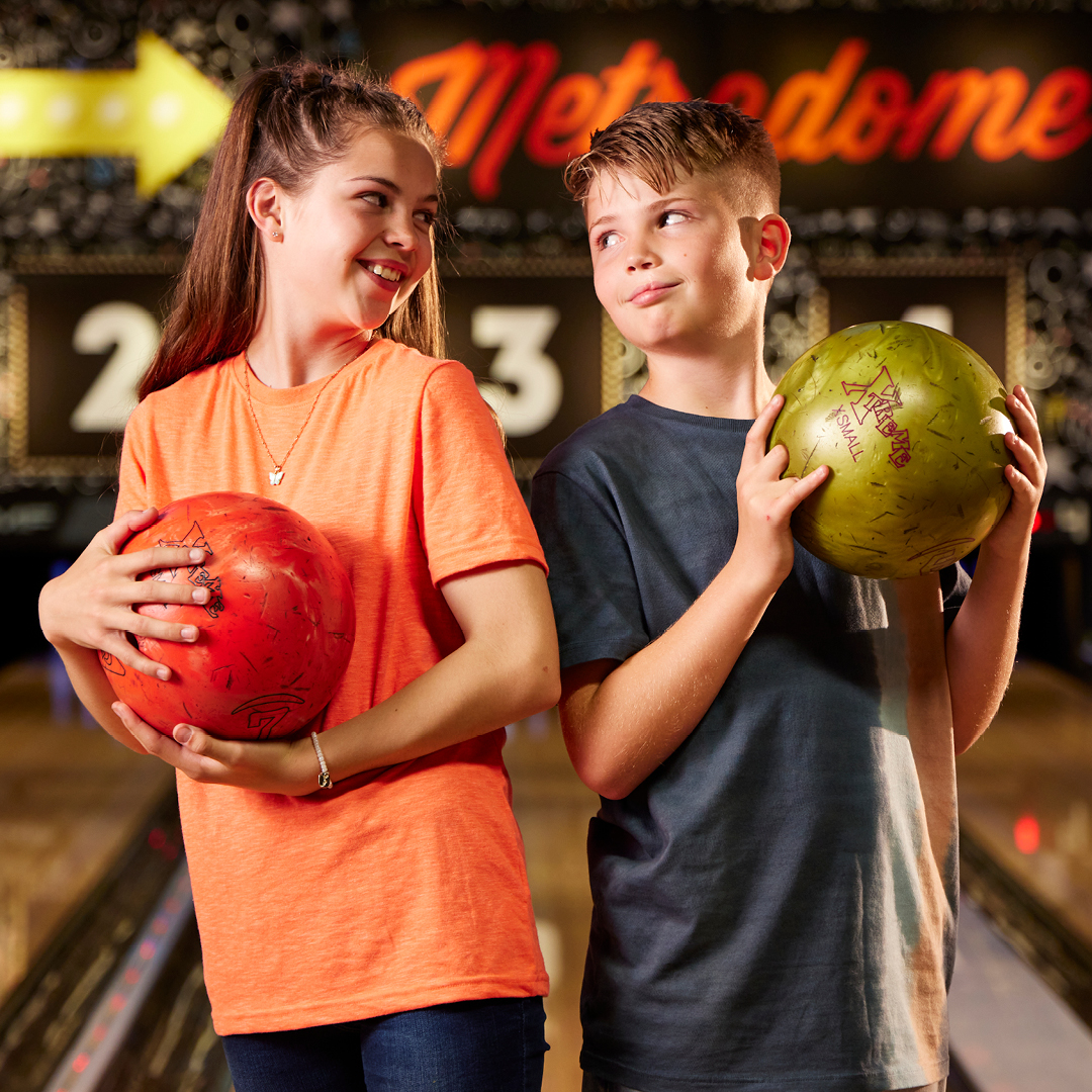 boy and girl bowling