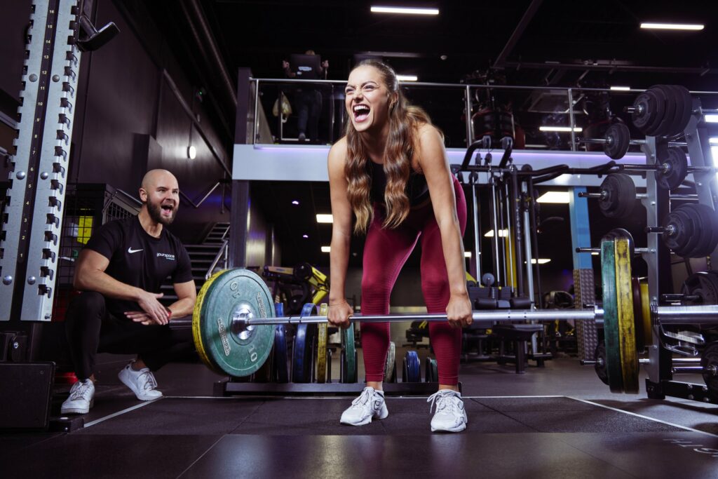 Girl lifting a barbell in gym